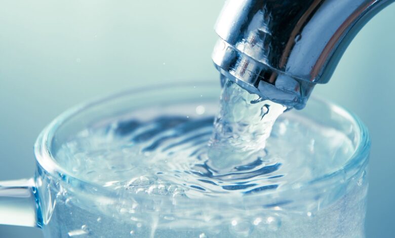 Close-up of water flowing from tap into glass