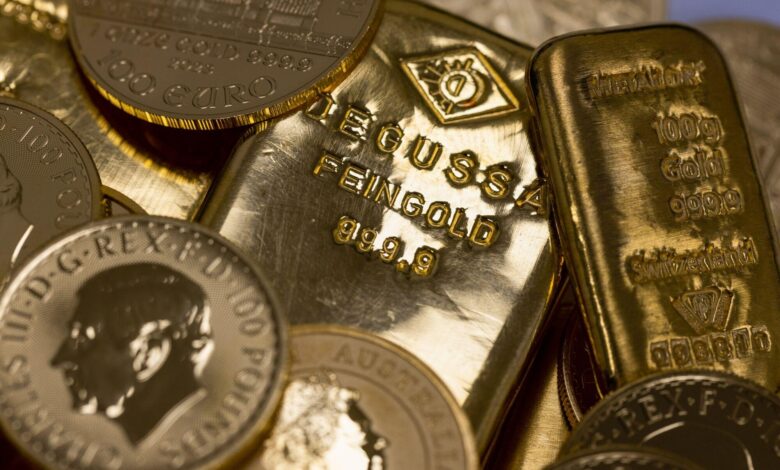 Gold prices cool near record peak as dollar holds footing