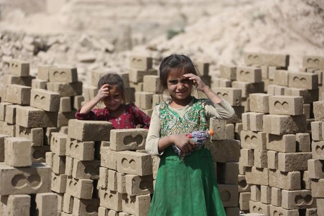 Afghan children work in brick kilns to support families