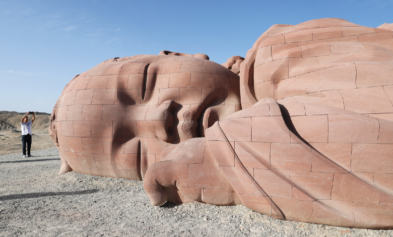 Giant baby sculpture draws visitors to desert